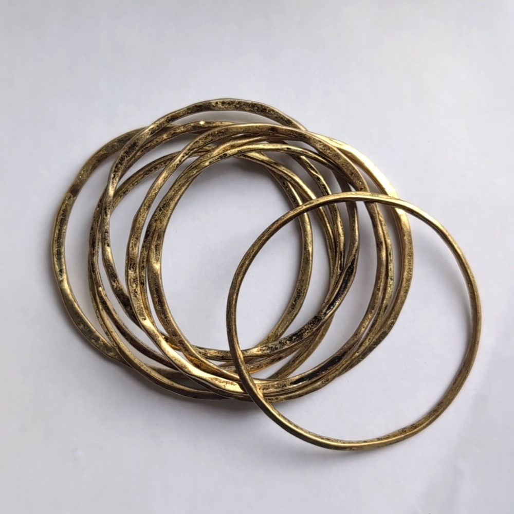 Topshop set of eight goldtone irregular metallic bracelets Multi layered